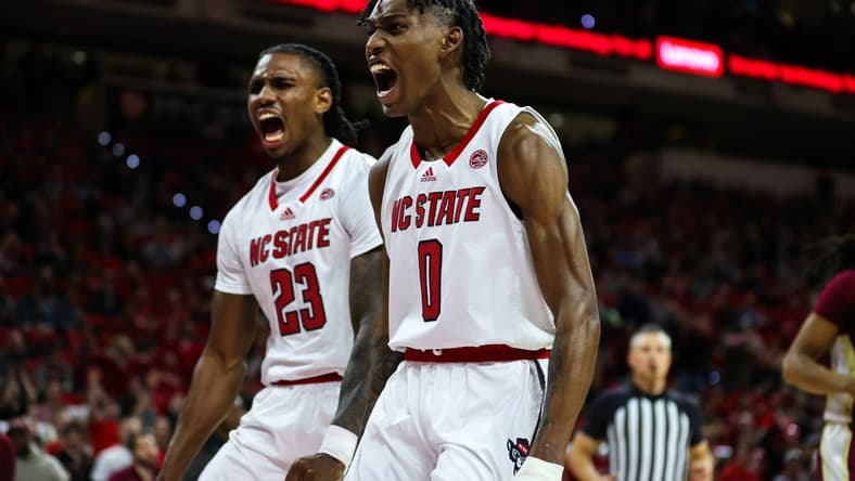 Feb 1, 2023; Raleigh, North Carolina, USA; North Carolina State Wolfpack guard Terquavion Smith (0) and North Carolina State Wolfpack forward Greg Gantt (23) react to a basket scored during the first half against Florida State at PNC Arena. Mandatory Credit: Jaylynn Nash-USA TODAY Sports