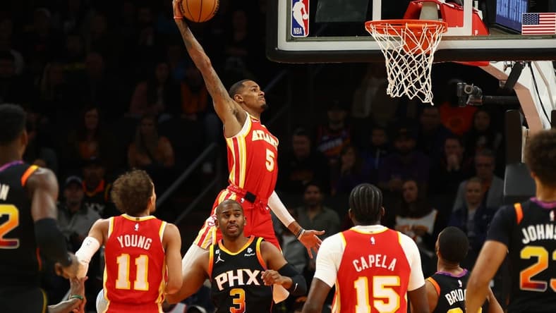 Feb 1, 2023; Phoenix, Arizona, USA; Atlanta Hawks guard Dejounte Murray (5) slam dunks the ball against the Phoenix Suns in the first half at Footprint Center. Mandatory Credit: Mark J. Rebilas-USA TODAY Sports