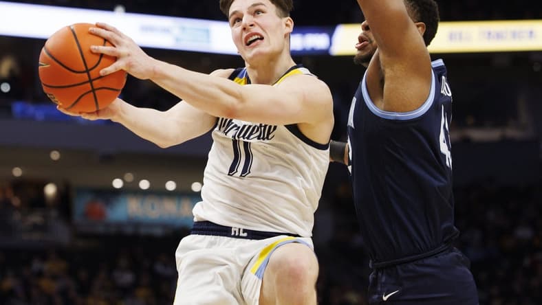 Feb 1, 2023; Milwaukee, Wisconsin, USA; Marquette Golden Eagles guard Tyler Kolek (11) shoots against Villanova Wildcats forward Eric Dixon (43) during the second half at Fiserv Forum. Mandatory Credit: Jeff Hanisch-USA TODAY Sports