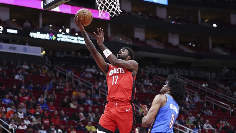 Feb 1, 2023; Houston, Texas, USA; Houston Rockets forward Tari Eason (17) shoots the ball as Oklahoma City Thunder forward Jalen Williams (8) defends during the first quarter at Toyota Center. Mandatory Credit: Troy Taormina-USA TODAY Sports