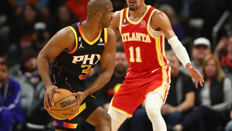 Feb 1, 2023; Phoenix, Arizona, USA; Phoenix Suns guard Chris Paul (3) controls the ball against Atlanta Hawks guard Trae Young (11) in the second half at Footprint Center. Mandatory Credit: Mark J. Rebilas-USA TODAY Sports