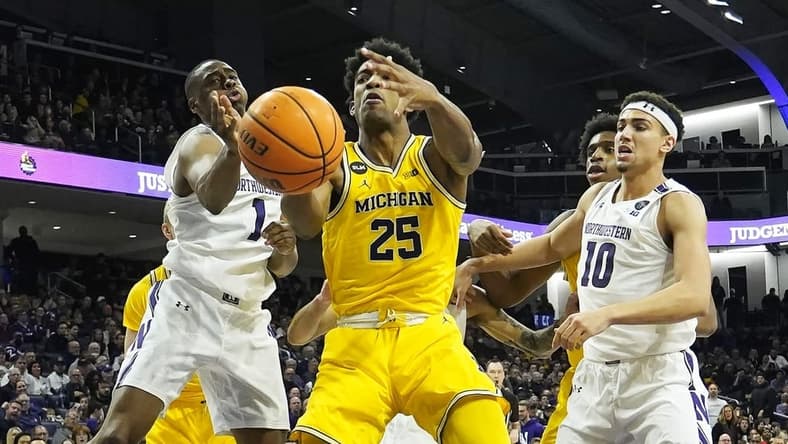 Feb 2, 2023; Evanston, Illinois, USA; Northwestern Wildcats guard Chase Audige (1) defends Michigan Wolverines guard Jace Howard (25) during the first half at Welsh-Ryan Arena. Mandatory Credit: David Banks-USA TODAY Sports