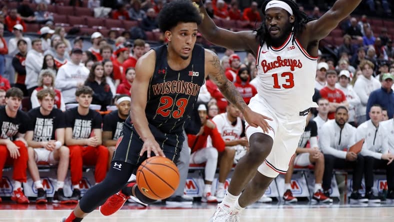Feb 2, 2023; Columbus, Ohio, USA;  Wisconsin Badgers guard Chucky Hepburn (23) dribbles past Ohio State Buckeyes guard Isaac Likekele (13) who is defending on the play during the first half at Value City Arena. Mandatory Credit: Joseph Maiorana-USA TODAY Sports