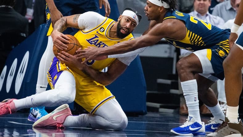 Feb 2, 2023; Indianapolis, Indiana, USA; Los Angeles Lakers forward Anthony Davis (3) grabs a loose the ball while Indiana Pacers guard Buddy Hield (24) defends in the first quarter at Gainbridge Fieldhouse. Mandatory Credit: Trevor Ruszkowski-USA TODAY Sports