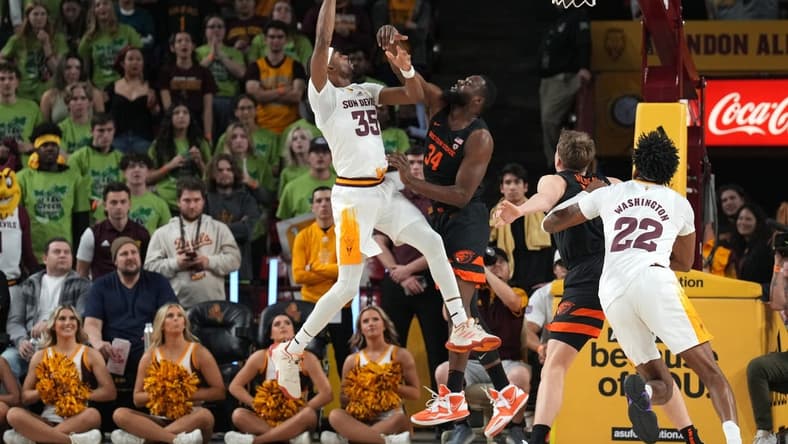 Feb 2, 2023; Tempe, Arizona, USA; Arizona State Sun Devils guard Devan Cambridge (35) shoots over Oregon State Beavers forward Rodrigue Andela (34) during the first half at Desert Financial Arena. Mandatory Credit: Joe Camporeale-USA TODAY Sports