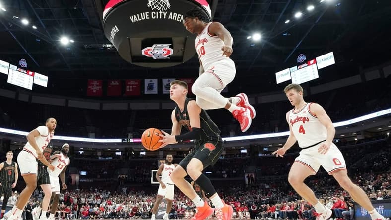 Feb 2, 2023; Columbus, OH, USA; Ohio State Buckeyes forward Brice Sensabaugh (10) leaps over Wisconsin Badgers guard Connor Essegian (3) during the first half of the NCAA men s basketball game at Value City Arena. Ohio State lost 65-60. Mandatory Credit: Adam Cairns-The Columbus Dispatch
Basketball Ceb Mbk Wisconsin Wisconsin At Ohio State