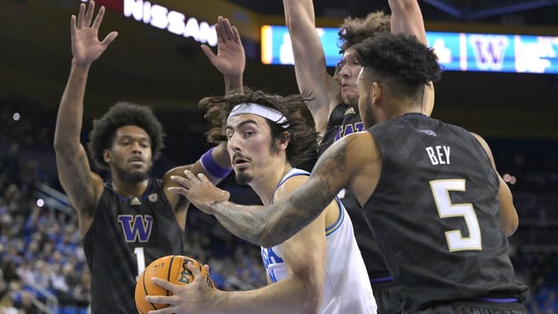 Feb 2, 2023; Los Angeles, California, USA; UCLA Bruins guard Jaime Jaquez Jr. (24) is defended under the basket by Washington Huskies guard Jamal Bey (5) and forward Keion Brooks (1) in the first half at Pauley Pavilion presented by Wescom. Mandatory Credit: Jayne Kamin-Oncea-USA TODAY Sports