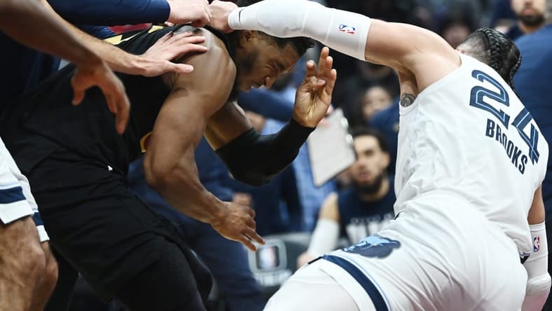 Feb 2, 2023; Cleveland, Ohio, USA; Cleveland Cavaliers guard Donovan Mitchell (45) fights with Memphis Grizzlies forward Dillon Brooks (24) during the second half at Rocket Mortgage FieldHouse. Both players were ejected. Mandatory Credit: Ken Blaze-USA TODAY Sports