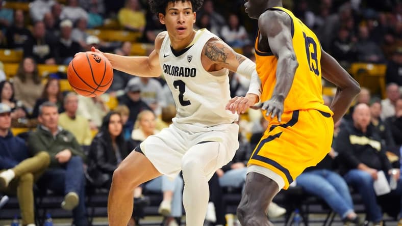Feb 2, 2023; Boulder, Colorado, USA; Colorado Buffaloes guard KJ Simpson (2) drives at California Golden Bears forward Kuany Kuany (13) in the first half at the CU Events Center. Mandatory Credit: Ron Chenoy-USA TODAY Sports