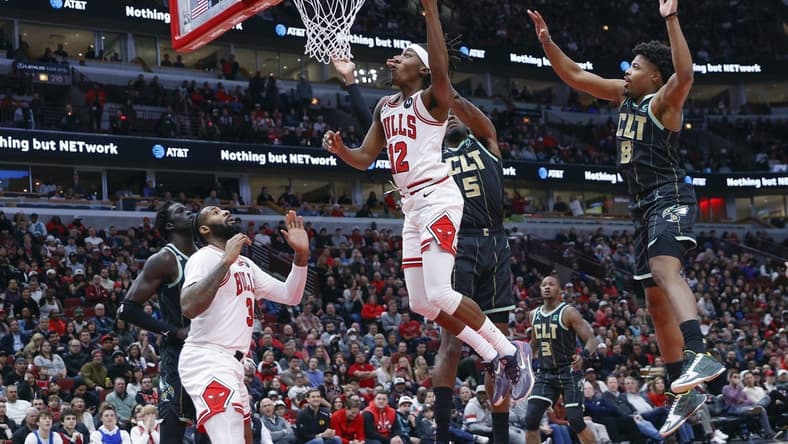 Feb 2, 2023; Chicago, Illinois, USA; Chicago Bulls guard Ayo Dosunmu (12) goes to the basket against the Charlotte Hornets during the first half at United Center. Mandatory Credit: Kamil Krzaczynski-USA TODAY Sports