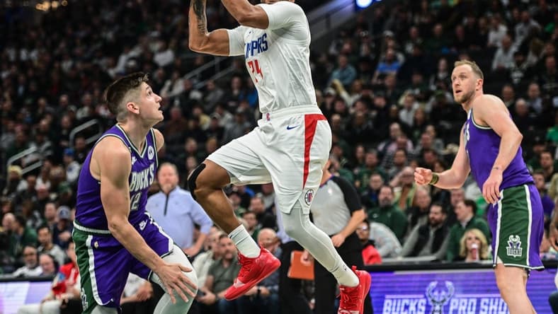Feb 2, 2023; Milwaukee, Wisconsin, USA; Los Angeles Clippers guard Norman Powell (24) shoots against Milwaukee Bucks guard Grayson Allen (12) in the second quarter at Fiserv Forum. Mandatory Credit: Benny Sieu-USA TODAY Sports