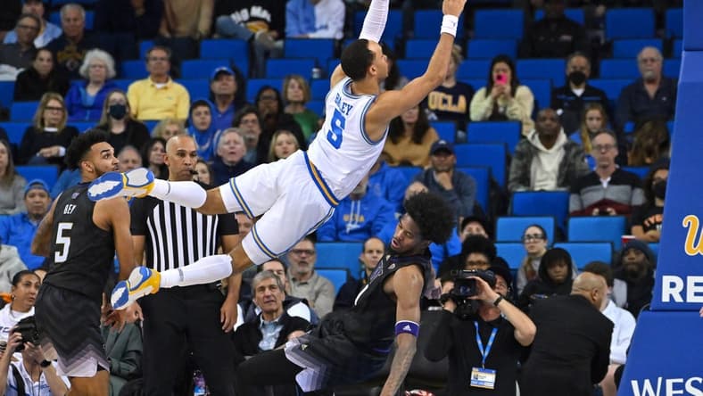 Feb 2, 2023; Los Angeles, California, USA; UCLA Bruins guard Amari Bailey (5) is charged with an offensive foul on Washington Huskies forward Keion Brooks (1) in the second half at Pauley Pavilion presented by Wescom. Mandatory Credit: Jayne Kamin-Oncea-USA TODAY Sports