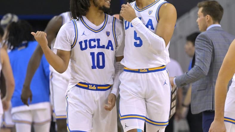 Feb 2, 2023; Los Angeles, California, USA; UCLA Bruins guard Tyger Campbell (10) and guard Amari Bailey (5) talk during a time out in the second half against the Washington Huskies at Pauley Pavilion presented by Wescom. Mandatory Credit: Jayne Kamin-Oncea-USA TODAY Sports