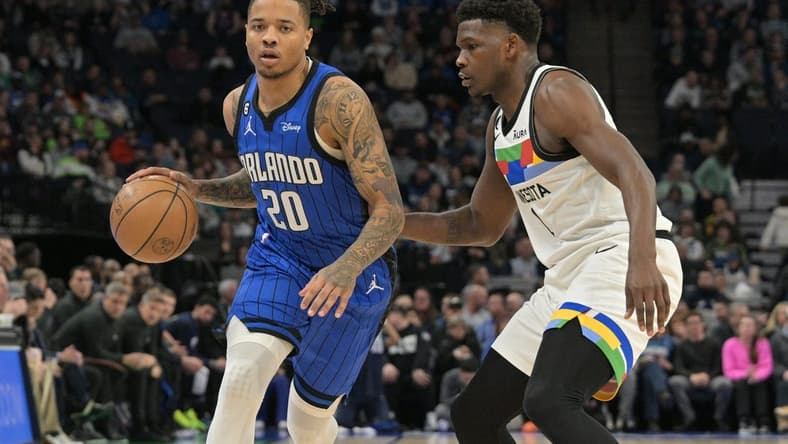 Feb 3, 2023; Minneapolis, Minnesota, USA; Orlando Magic guard Markelle Fultz (20) is defended by Minnesota Timberwolves guard Anthony Edwards (1) during the first quarter at Target Center. Mandatory Credit: Jeffrey Becker-USA TODAY Sports