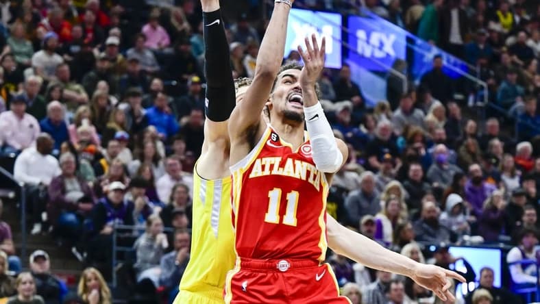 Feb 3, 2023; Salt Lake City, Utah, USA; Atlanta Hawks guard Trae Young (11) takes a shot around Utah Jazz forward/center Lauri Markkanen (23) during the first half at Vivint Arena. Mandatory Credit: Christopher Creveling-USA TODAY Sports