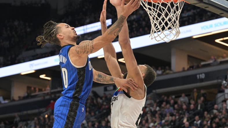 Feb 3, 2023; Minneapolis, Minnesota, USA; Orlando Magic guard Cole Anthony (50) goes to the basket as Minnesota Timberwolves center Rudy Gobert (27) defends during the second quarter at Target Center. Mandatory Credit: Jeffrey Becker-USA TODAY Sports