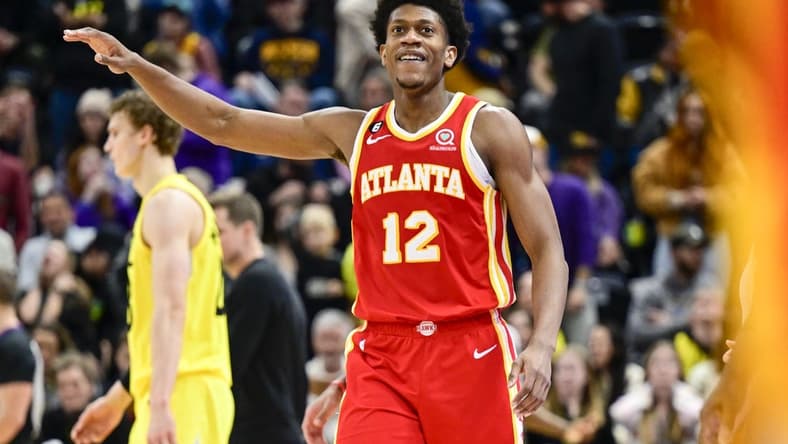 Feb 3, 2023; Salt Lake City, Utah, USA; Atlanta Hawks forward/guard De'Andre Hunter (12) reacts after making a three point basket against the Utah Jazz during the second half at Vivint Arena. Mandatory Credit: Christopher Creveling-USA TODAY Sports