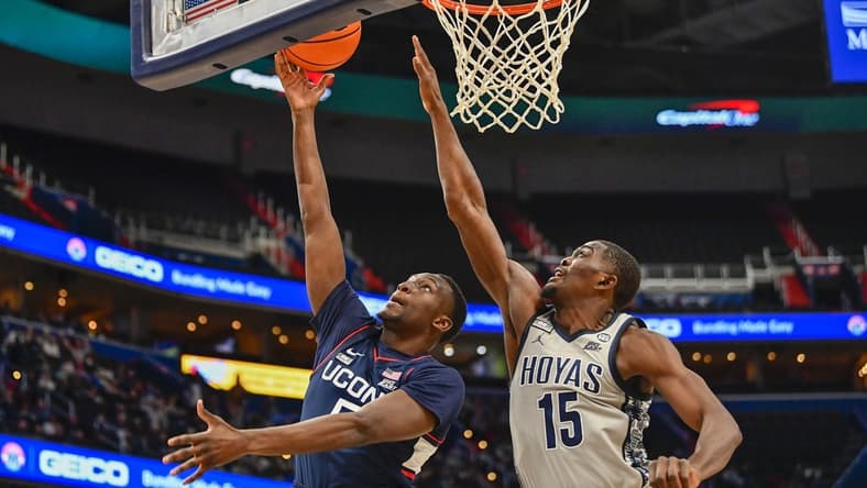 Feb 4, 2023; Washington, District of Columbia, USA; Connecticut Huskies guard Hassan Diarra (5) shoots as Georgetown Hoyas forward Bryson Mozone (15) defends during the first half at Capital One Arena. Mandatory Credit: Brad Mills-USA TODAY Sports
