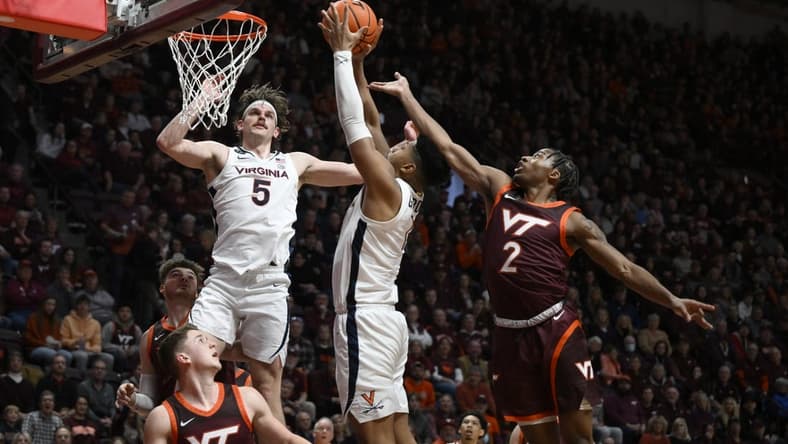 Feb 4, 2023; Blacksburg, Virginia, USA; Virginia Cavaliers forward Jayden Gardner (1) drives to basket as Virginia Tech Hokies guard Michael Collins Jr. (2) defends at Cassell Coliseum in the first half. Mandatory Credit: Lee Luther Jr.-USA TODAY Sports