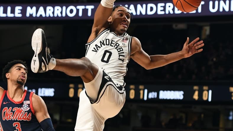 Feb 4, 2023; Nashville, Tennessee, USA; Vanderbilt Commodores guard Tyrin Lawrence (0) is fouled by Mississippi Rebels forward Myles Burns (3) during the first half at Memorial Gymnasium. Mandatory Credit: Christopher Hanewinckel-USA TODAY Sports