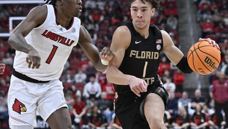 Feb 4, 2023; Louisville, Kentucky, USA; Florida State Seminoles guard Jalen Warley (1) dribbles against Louisville Cardinals guard Mike James (1) during the first half at KFC Yum! Center. Mandatory Credit: Jamie Rhodes-USA TODAY Sports