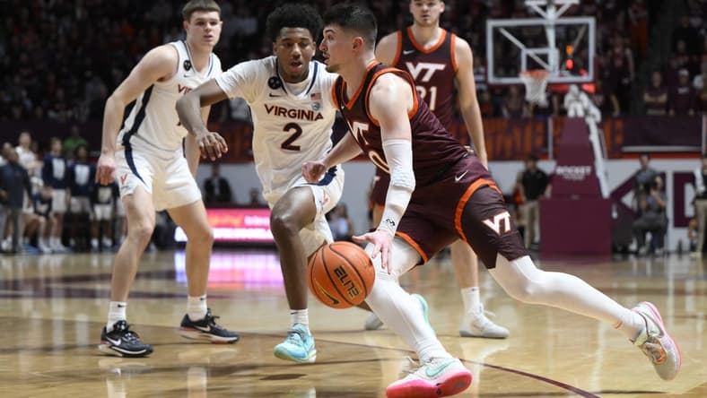 Feb 4, 2023; Blacksburg, Virginia, USA;  Virginia Tech Hokies guard Hunter Cattoor (0) dribbles around Boston College Eagles guard Michael Collins Jr. (2) in the second half at Cassell Coliseum. Mandatory Credit: Lee Luther Jr.-USA TODAY Sports
