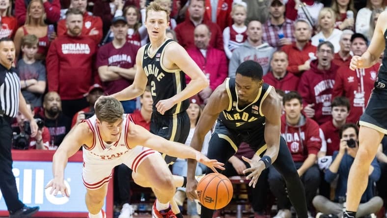 Feb 4, 2023; Bloomington, Indiana, USA; Indiana Hoosiers forward Miller Kopp (12) and Purdue Boilermakers guard Brandon Newman (5) dive for a loose ball in the first half at Simon Skjodt Assembly Hall. Mandatory Credit: Trevor Ruszkowski-USA TODAY Sports