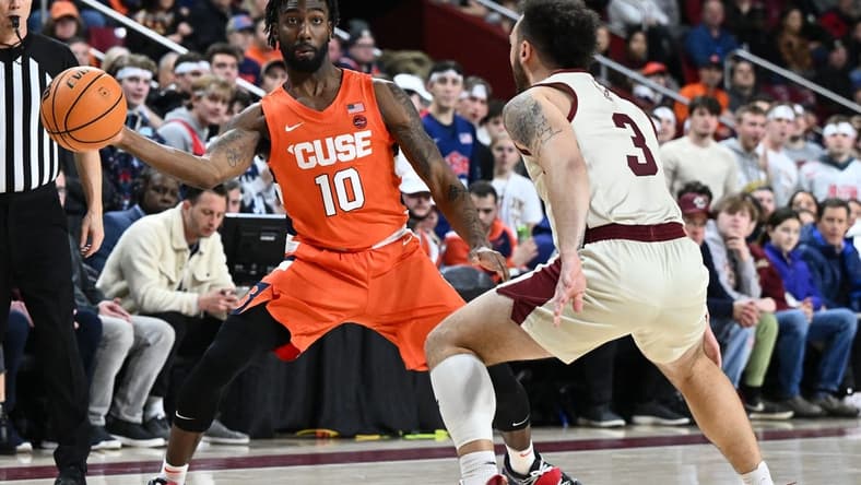 Feb 4, 2023; Chestnut Hill, Massachusetts, USA; Syracuse Orange guard Symir Torrence (10) passes the ball around Boston College Eagles guard Jaeden Zackery (3) during the first half at the Conte Forum. Mandatory Credit: Brian Fluharty-USA TODAY Sports
