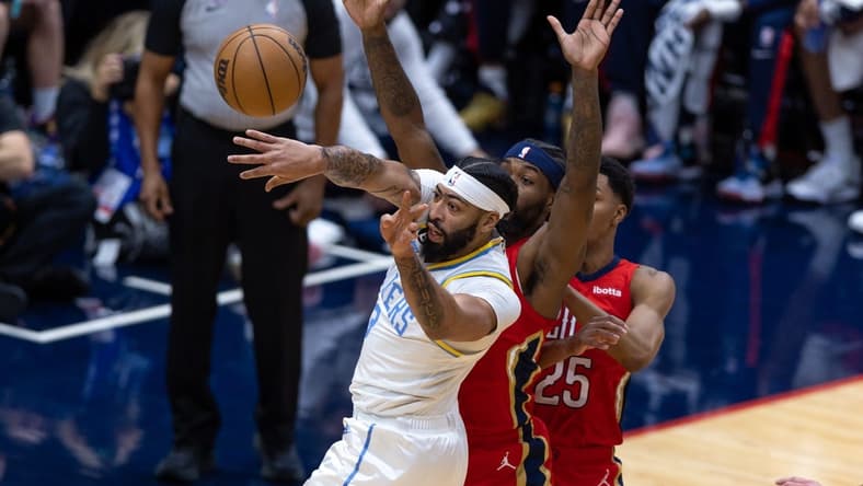 Feb 4, 2023; New Orleans, Louisiana, USA; Los Angeles Lakers forward Anthony Davis (3) passes the ball against New Orleans Pelicans guard Trey Murphy III (25) during the first half at Smoothie King Center. Mandatory Credit: Stephen Lew-USA TODAY Sports