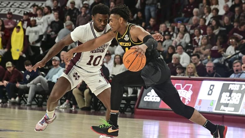 Feb 4, 2023; Starkville, Mississippi, USA; Missouri Tigers guard DeAndre Gholston (4) handles the ball while defended by Mississippi State Bulldogs guard Dashawn Davis (10) during the first half at Humphrey Coliseum. Mandatory Credit: Matt Bush-USA TODAY Sports