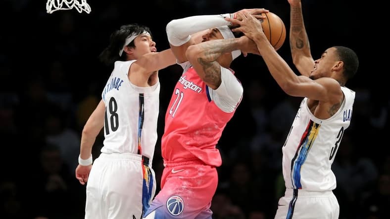Feb 4, 2023; Brooklyn, New York, USA; Washington Wizards center Daniel Gafford (21) fights for the ball against Brooklyn Nets forward Yuta Watanabe (18) and center Nic Claxton (33) during the first quarter at Barclays Center. Mandatory Credit: Brad Penner-USA TODAY Sports