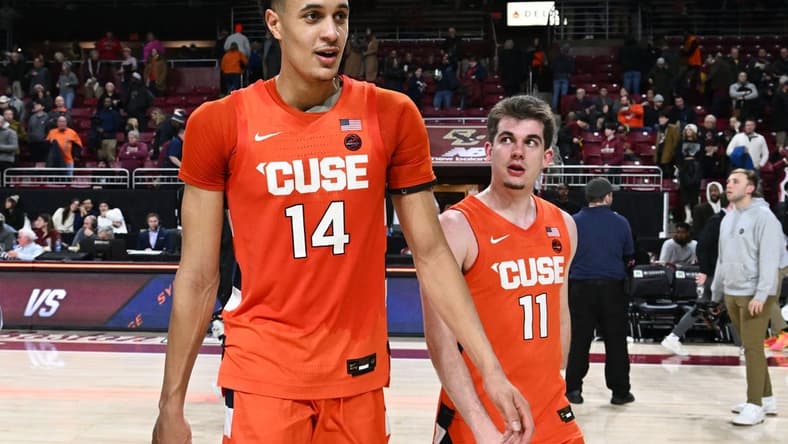 Feb 4, 2023; Chestnut Hill, Massachusetts, USA; Syracuse Orange center Jesse Edwards (14) walks off of the court with guard Joseph Girard III (11) after a game against the Boston College Eagles at the Conte Forum. Mandatory Credit: Brian Fluharty-USA TODAY Sports