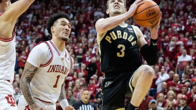 Feb 4, 2023; Bloomington, Indiana, USA; Purdue Boilermakers guard Braden Smith (3) shoots the ball while Indiana Hoosiers guard Jalen Hood-Schifino (1) defends in the second half at Simon Skjodt Assembly Hall. Mandatory Credit: Trevor Ruszkowski-USA TODAY Sports