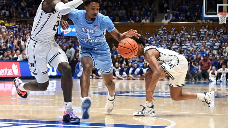 Feb 4, 2023; Durham, North Carolina, USA; North Carolina Tar Heels guard Leaky Black (1) drives to the basket as Duke Blue Devils forward Mark Mitchell (25) defends during the first half at Cameron Indoor Stadium. Mandatory Credit: Rob Kinnan-USA TODAY Sports