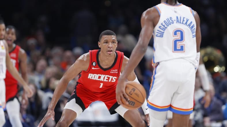 Feb 4, 2023; Oklahoma City, Oklahoma, USA; Houston Rockets forward Jabari Smith Jr. (1) defends Oklahoma City Thunder guard Shai Gilgeous-Alexander (2) during the second quarter at Paycom Center. Mandatory Credit: Alonzo Adams-USA TODAY Sports