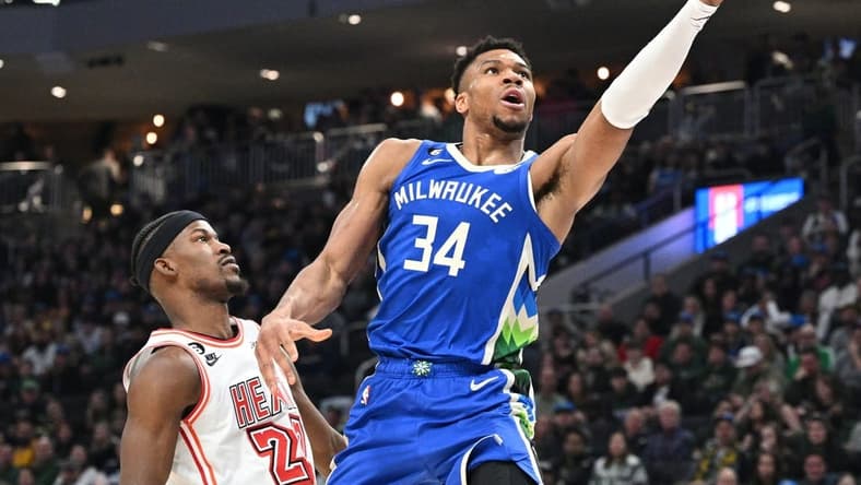 Feb 4, 2023; Milwaukee, Wisconsin, USA; Milwaukee Bucks forward Giannis Antetokounmpo (34) drives to the basket against Miami Heat forward Jimmy Butler (22) in the first half at Fiserv Forum. Mandatory Credit: Michael McLoone-USA TODAY Sports