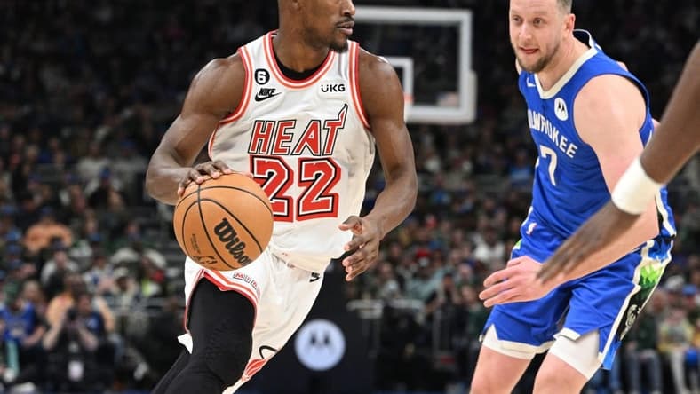 Feb 4, 2023; Milwaukee, Wisconsin, USA; Miami Heat forward Jimmy Butler (22) drives to the basket against Milwaukee Bucks guard Joe Ingles (7) in the second half at Fiserv Forum. Mandatory Credit: Michael McLoone-USA TODAY Sports