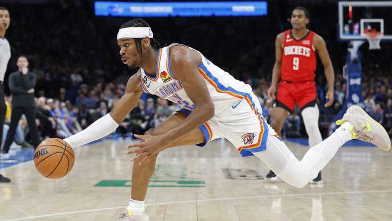 Feb 4, 2023; Oklahoma City, Oklahoma, USA; Oklahoma City Thunder guard Shai Gilgeous-Alexander (2) reaches for a loose ball during the first quarter against the Houston Rockets at Paycom Center. Mandatory Credit: Alonzo Adams-USA TODAY Sports