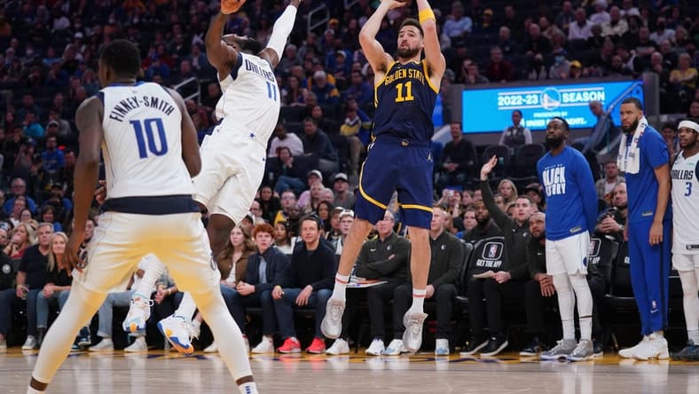 Feb 4, 2023; San Francisco, California, USA; Golden State Warriors guard Klay Thompson (11) shoots the ball over Dallas Mavericks forward Tim Hardaway Jr. (11) in the fourth quarter at the Chase Center. Mandatory Credit: Cary Edmondson-USA TODAY Sports