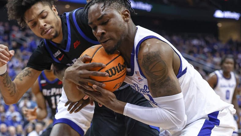 Feb 5, 2023; Newark, New Jersey, USA; Seton Hall Pirates forward KC Ndefo (13) secures a loose ball against DePaul Blue Demons guard Caleb Murphy (23) during the first half at Prudential Center. Mandatory Credit: Vincent Carchietta-USA TODAY Sports