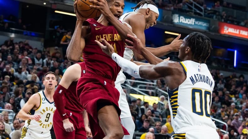 Feb 5, 2023; Indianapolis, Indiana, USA; Cleveland Cavaliers forward Evan Mobley (4) rebounds the ball while Indiana Pacers guard Bennedict Mathurin (00) defends in the second quarter at Gainbridge Fieldhouse. Mandatory Credit: Trevor Ruszkowski-USA TODAY Sports