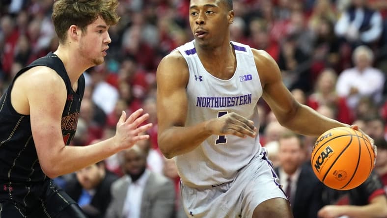 Feb 5, 2023; Madison, Wisconsin, USA; Northwestern Wildcats guard Chase Audige (1) dribbles the ball while defended by Wisconsin Badgers guard Max Klesmit (11) during the first half at the Kohl Center. Mandatory Credit: Kayla Wolf-USA TODAY Sports
