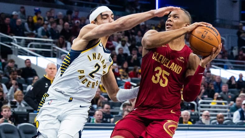 Feb 5, 2023; Indianapolis, Indiana, USA; Cleveland Cavaliers forward Isaac Okoro (35) shoots the ball while Indiana Pacers guard Andrew Nembhard (2) defends in the second half at Gainbridge Fieldhouse. Mandatory Credit: Trevor Ruszkowski-USA TODAY Sports