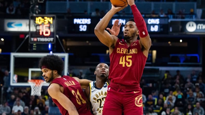Feb 5, 2023; Indianapolis, Indiana, USA; Cleveland Cavaliers guard Donovan Mitchell (45) shoots the ball while  Indiana Pacers forward Aaron Nesmith (23) defends in the second half at Gainbridge Fieldhouse. Mandatory Credit: Trevor Ruszkowski-USA TODAY Sports