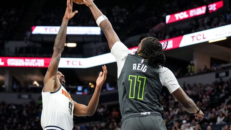 Feb 5, 2023; Minneapolis, Minnesota, USA; Denver Nuggets guard Davon Reed (9) is blocked by Minnesota Timberwolves center Naz Reid (11) during the second quarter at Target Center. Mandatory Credit: Brace Hemmelgarn-USA TODAY Sports