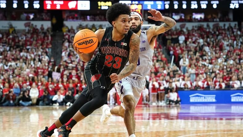 Feb 5, 2023; Madison, Wisconsin, USA; Wisconsin Badgers guard Chucky Hepburn (23) drives to the basket while defended by Northwestern Wildcats guard Boo Buie (0) during the second half at the Kohl Center. Mandatory Credit: Kayla Wolf-USA TODAY Sports