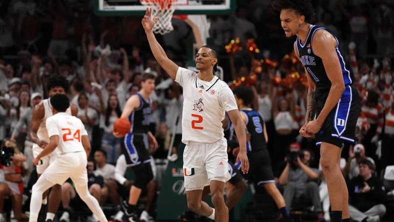Feb 6, 2023; Coral Gables, Florida, USA; Miami Hurricanes guard Isaiah Wong (2) gestures after making a three point shot over Duke Blue Devils center Dereck Lively II (1) during the first half at Watsco Center. Mandatory Credit: Jasen Vinlove-USA TODAY Sports