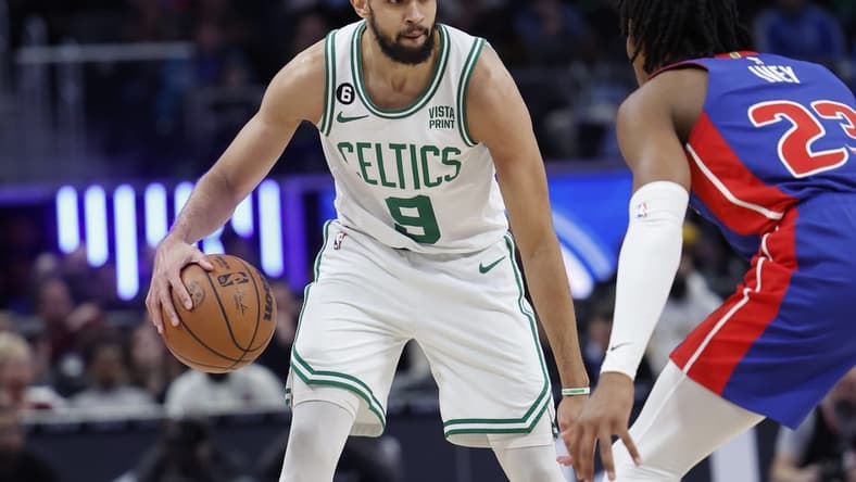 Feb 6, 2023; Detroit, Michigan, USA; Boston Celtics guard Derrick White (9) dribbles defended by Detroit Pistons guard Jaden Ivey (23) in the first half at Little Caesars Arena. Mandatory Credit: Rick Osentoski-USA TODAY Sports