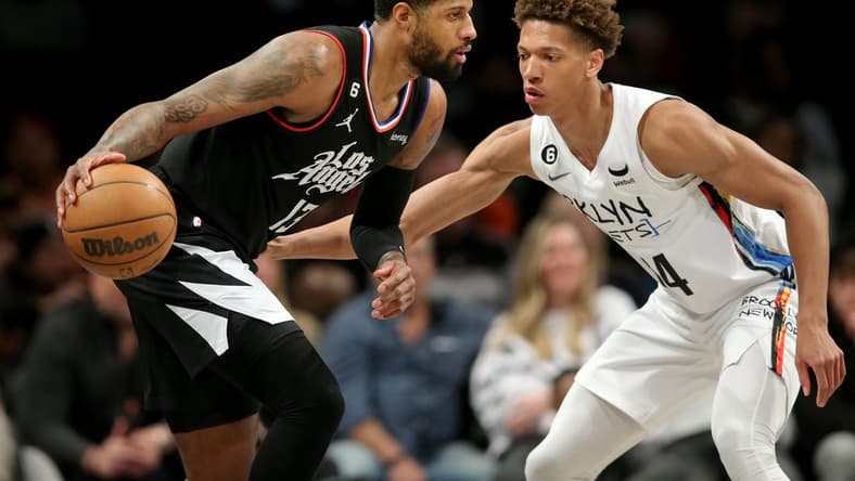 Feb 6, 2023; Brooklyn, New York, USA; Los Angeles Clippers guard Paul George (13) controls the ball against Brooklyn Nets forward Kessler Edwards (14) during the second quarter at Barclays Center. Mandatory Credit: Brad Penner-USA TODAY Sports