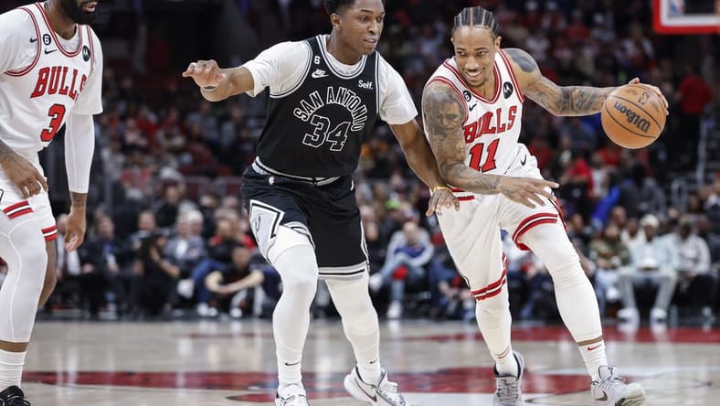 Feb 6, 2023; Chicago, Illinois, USA; Chicago Bulls forward DeMar DeRozan (11) drives to the basket against San Antonio Spurs forward Stanley Johnson (34) during the first half at United Center. Mandatory Credit: Kamil Krzaczynski-USA TODAY Sports